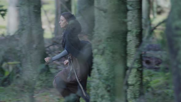 Woman running through the forest