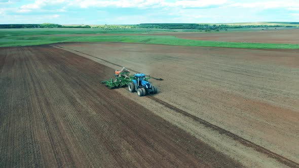 Tractor Is Riding Along the Field and Sowing It