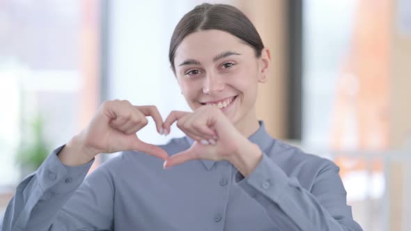 Portrait of Young Latin Woman Showing Heart Shape By Hands