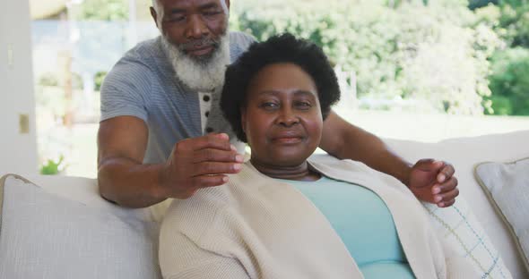 Happy senior african american couple embracing and smiling