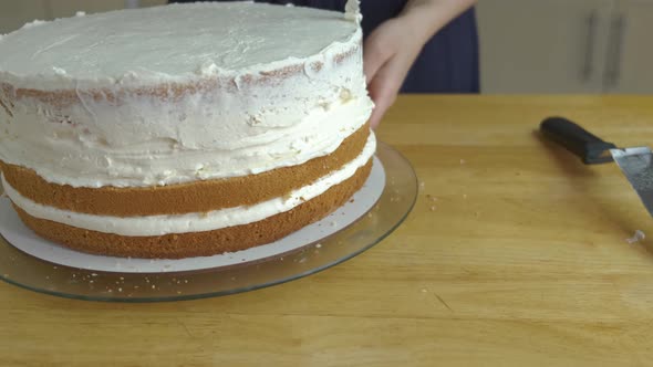 Close Up of Woman Hands Making Sweet Cake with White Cream and Biscuit