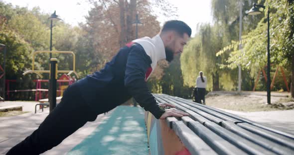 Pushups  Man Fitness Model Training Push Ups at Sport Ground Outdoor Training