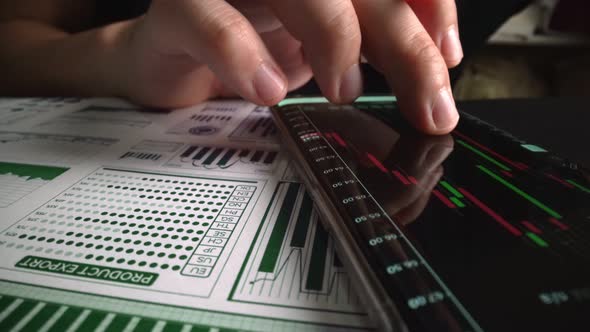 Accountant Analyzing Business Marketing Data on Paper Dashboard at Office Table