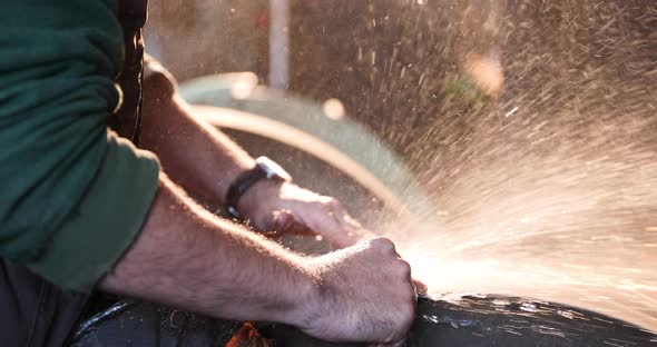 Bladesmith wet grinding a blade