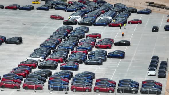 Brand new Tesla Model Y cars manufactured at Giga Texas. Aerial reveal of factory parking lot in Aus