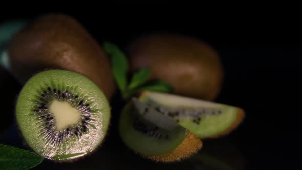 Fruits of Juicy Kiwi Lie on a Table on a Black Background