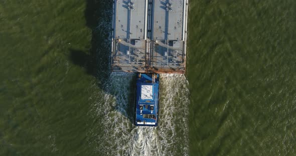 Aerial establishing shot of large tanker boat in water