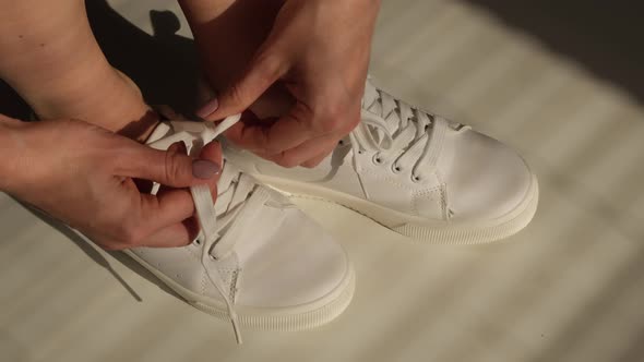 Woman Put on New White Leather Sneakers