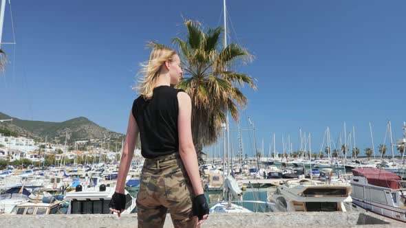 A Beautiful Blonde Girl on Skateboard in Summer Hot Day on Seafront