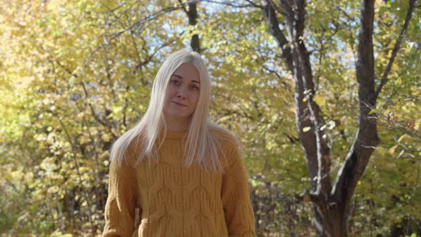 Portrait of a beautiful young woman in autumn forest