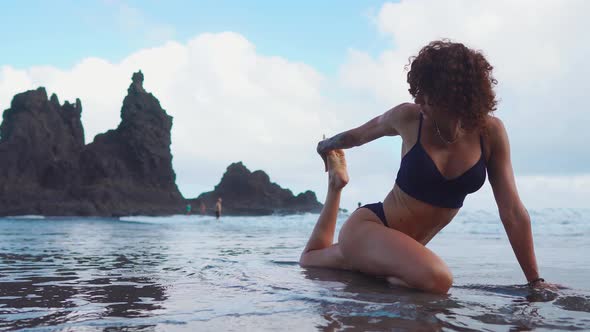 Fitness Girl or Young Woman in Shape Silhouette, Surfer Doing Some Stretching Exersices on Sandy