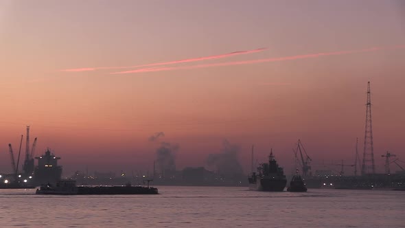 cargo ships coming in at dawn at the port of Antwerp and its industry