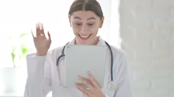 Portrait of Female Doctor doing Video Chat on Digital Tablet