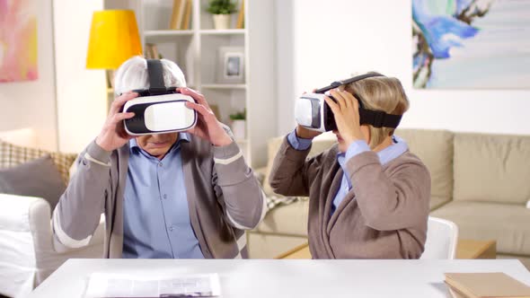 Aged Man and Woman Using VR Glasses