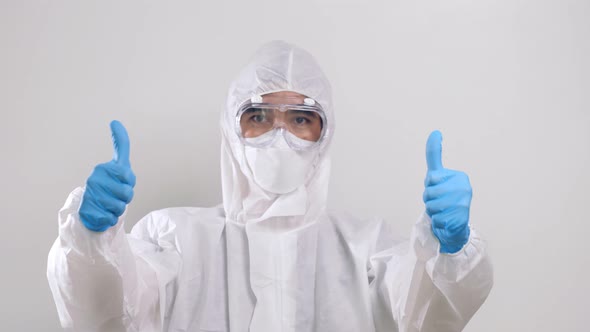 Medical worker portrait, Confident Asian doctor in protective PPE suit thumbs up