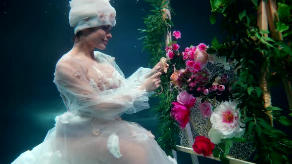 Fairytale Underwater Shot with Amazing Fairy Lady Sewing Flowers in Fabulous Undersea Garden