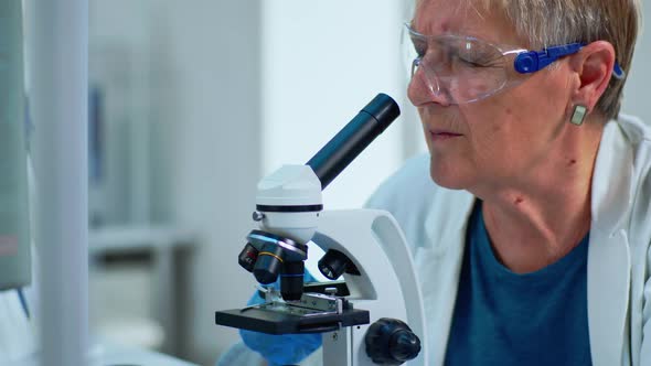 Close Up of Woman Research Scientist Looking at Samples Under Microscope