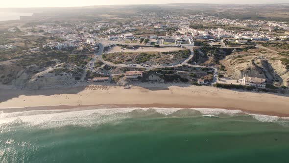 Dolly out aerial seascape of the secluded cove and beach in Sagres Algarve Portugal.