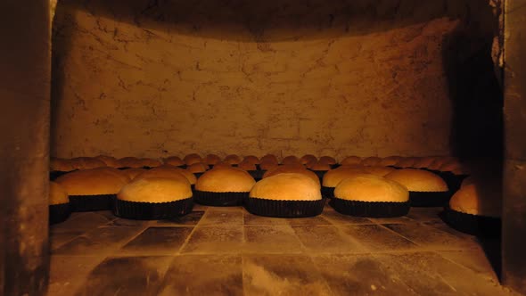 Rustic old retro oven that has lot of bread in it.