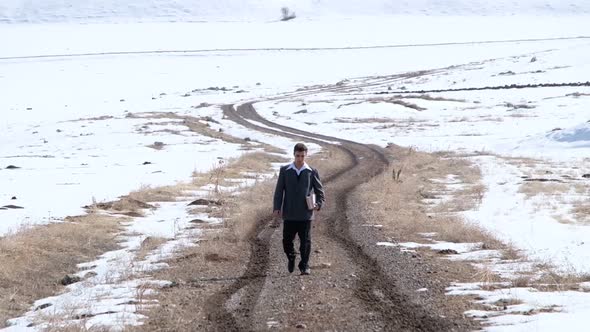 Young Man Walking The Village Road