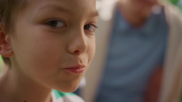 Cute Boy Eating Coockies Looking on Camera Close Up