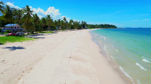 Drone flying at the tropical white beach with coconut trees