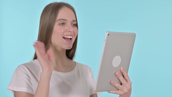 Video Chat on Tablet By Young Woman, Blue Background