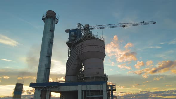 Aerial View of Cement Plant with High Factory Structure and Tower Crane at Industrial Production