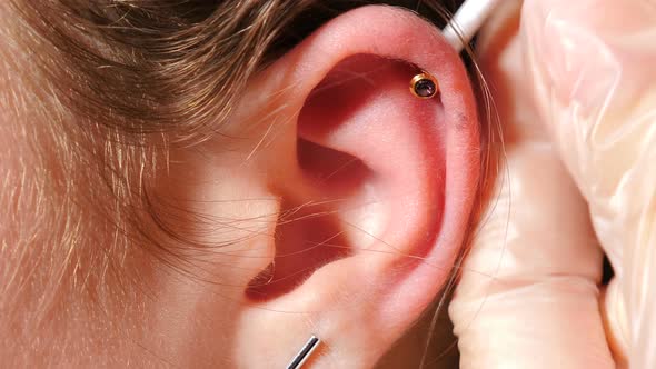 Pretty Teenaged Girl Having Her Ears Pierced