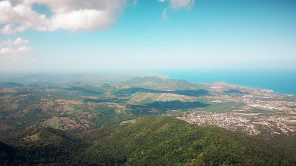 Flight over the green jungle that grows on the hills on Haiti island