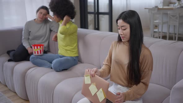 Tired Young Beautiful Asian Woman Closing Laptop Messaging Online and Holding Head in Hands