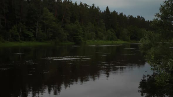 Dark waters of the river. Dramatic water twilight. Soft focus