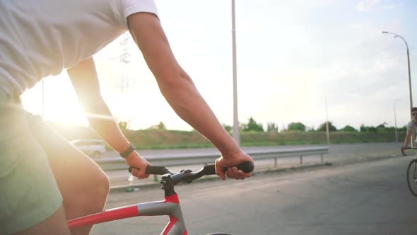 Group of Cyclists Riding Fixed Gear Bikes on the Road Steadycome Shot Slow Motion Giving High Five