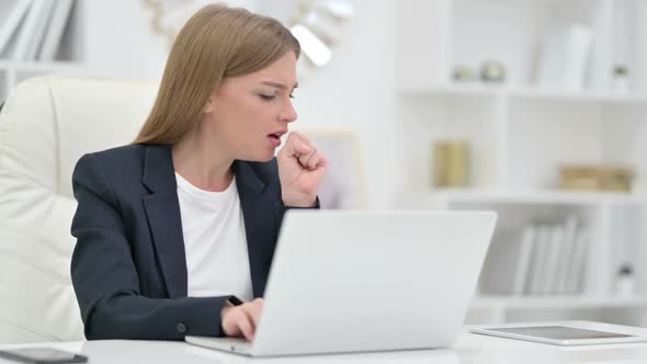 Sick Businesswoman with Laptop Coughing in Office