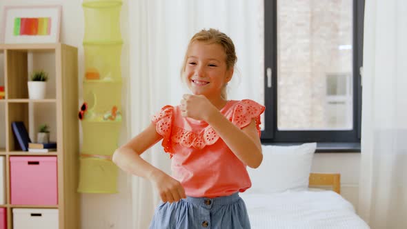 Happy Little Girl Dancing in Her Room at Home