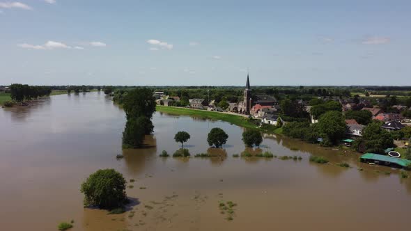 Flooded land and floodplains, drowned trees, river Maas village Appeltern