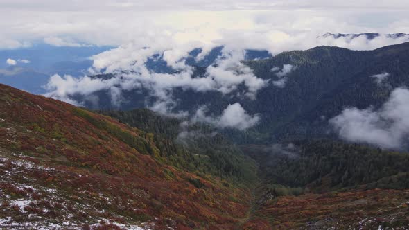 Mountain valley with fog and clouds at morning