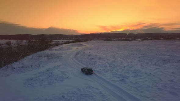 Drone shooting of river against background of a forest and a bridge, a car