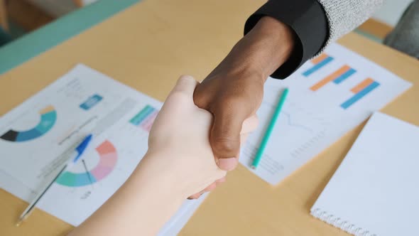 African Black Man Shake Hands with His Business Partner Caucasian Woman