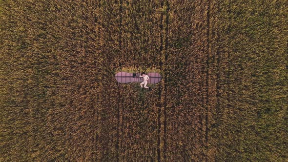 Pretty Lady Lies on Old Wooden Glider Wings Aerial Zoom Out