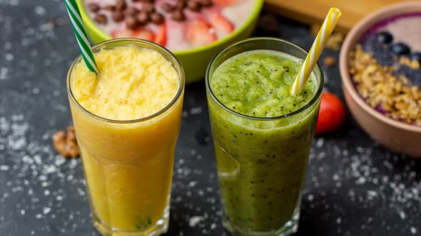 Freshly Blended Fruit Smoothies in Glasses. Yellow, Green Drinks