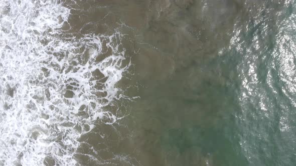 Aerial top down view of shimmering waves 