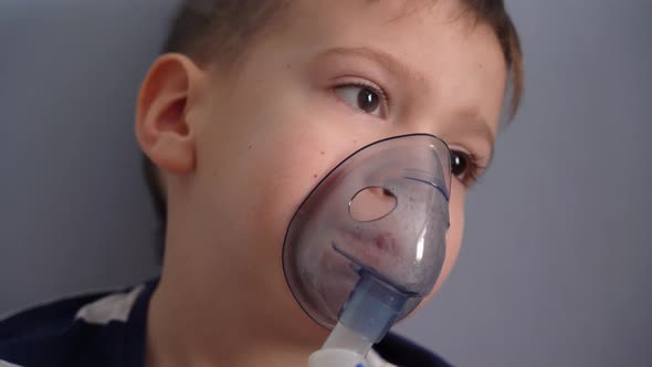 The child is sick and breathes with a nebulizer