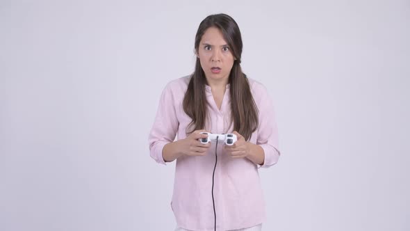 Young Stressed Multiethnic Businesswoman Playing Games and Losing