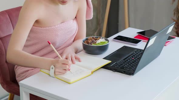 Business Lady with a Towel on Head Eating Healthy Breaksfast and Talking Online