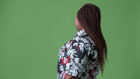 Overweight Beautiful African Woman Against Green Background