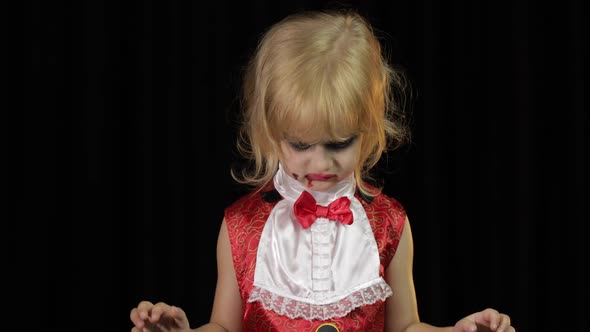 Dracula Child. Girl with Halloween Make-up. Vampire Kid with Blood on Her Face