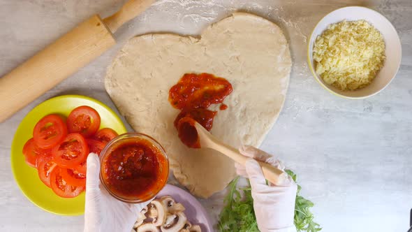 Closeup of Applying Fragrant Pizza Sauce