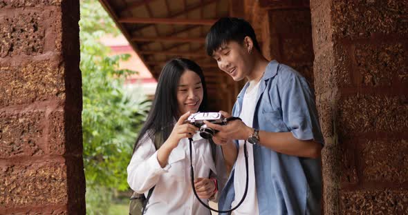 Couple standing and looking photo on camera