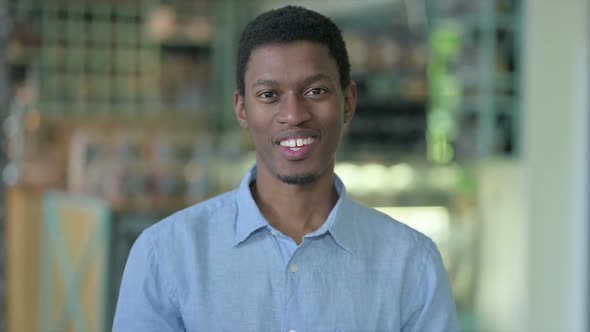 Portrait of Young African Man Talking on Video Call